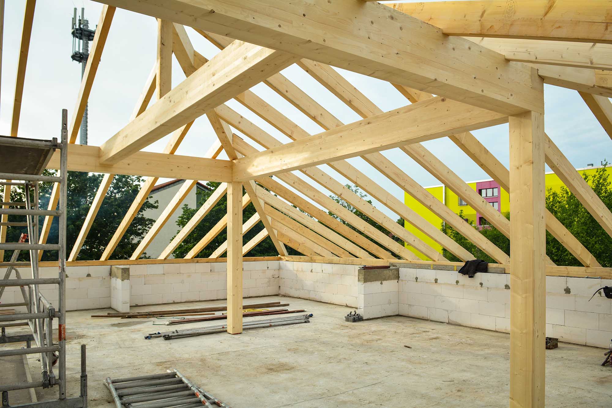 The wooden roof framing of an unfinished building under construction.